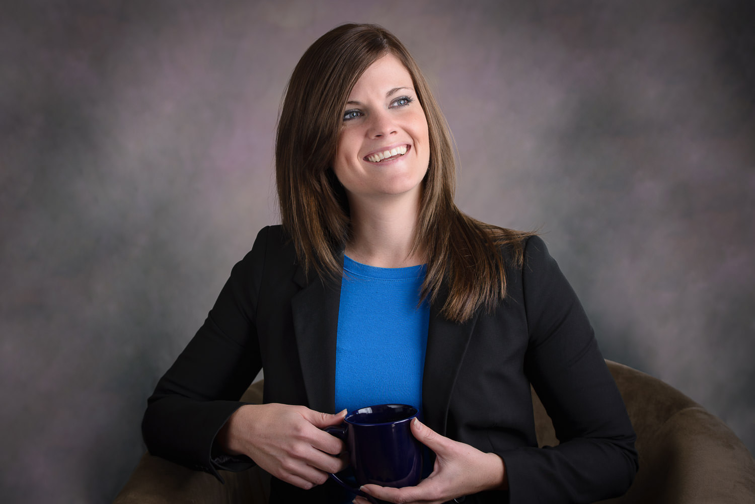 Marketing image of a business woman on a gray and purple background