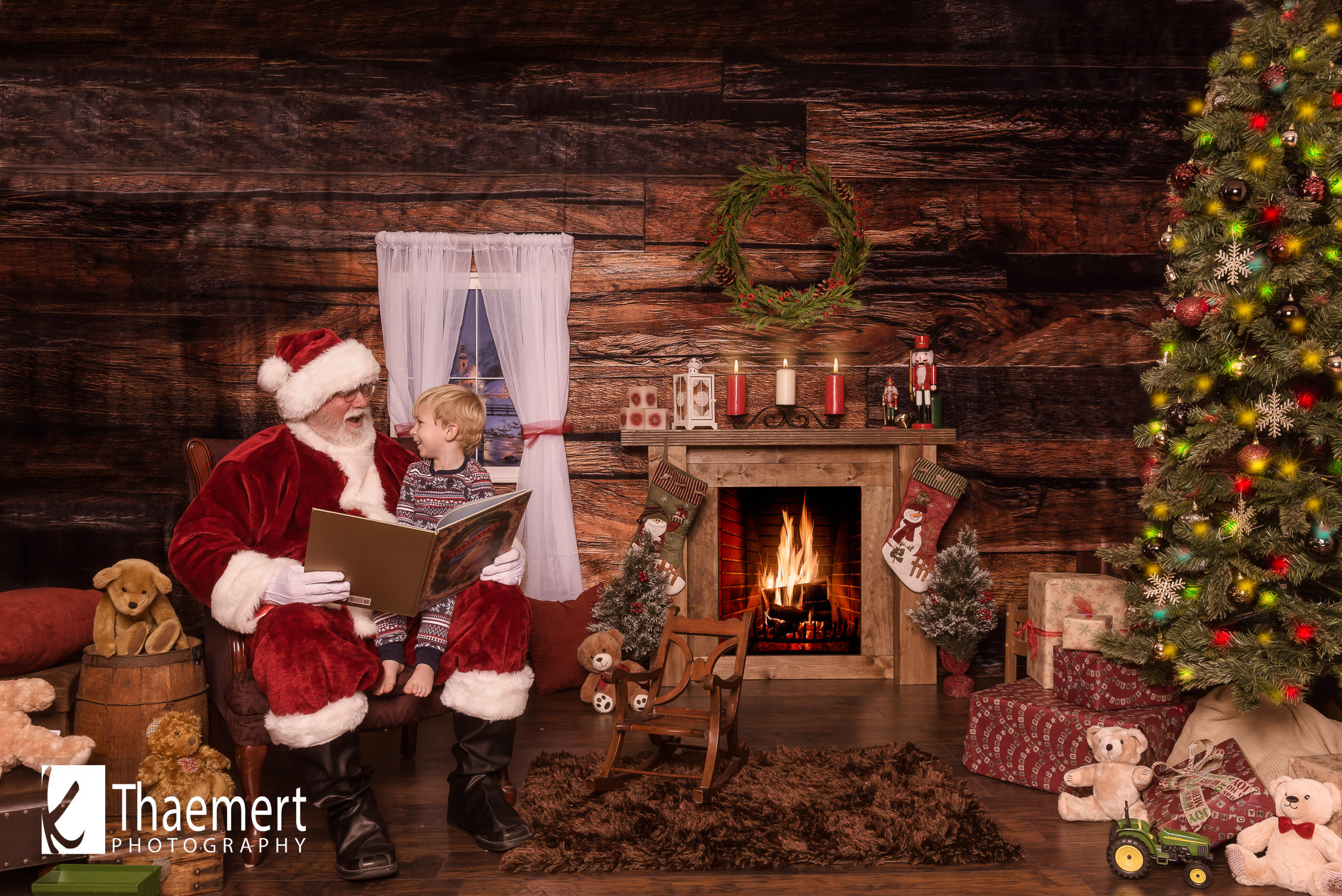 Little Boy Reads with Santa at his photo session