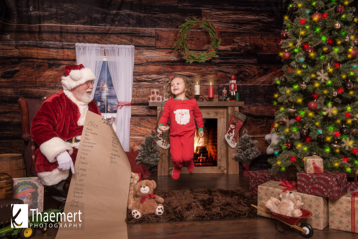 Little Girl Jumps for Joy while visiting with Santa