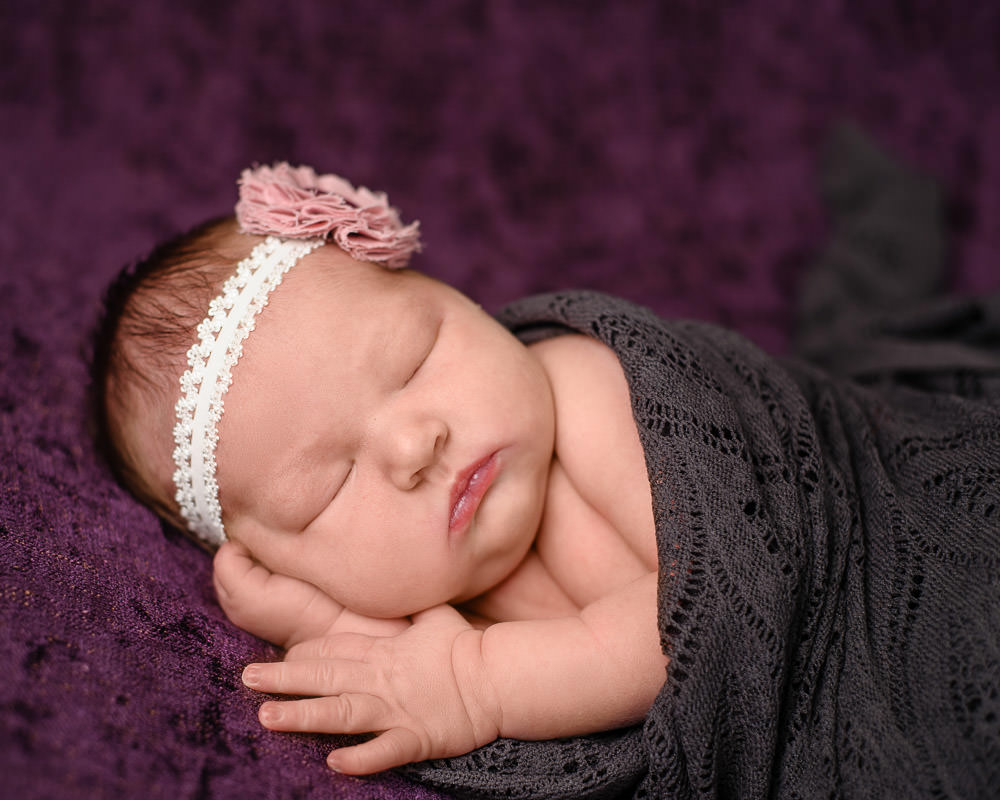 Newborn Baby Girl photography wrapped in deep jewel tone colors